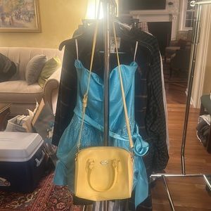 Light yellow coach purse with strap included